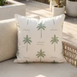 Tropica green cushion with palm tree pattern on outdoor lounge chair.
