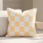 Tropica lemon yellow check cushion with soft white squares on sofa.
