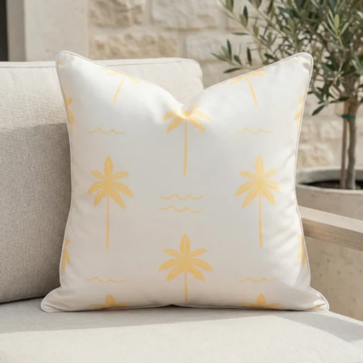 Tropica lemon yellow cushion with palm tree pattern on outdoor seating.