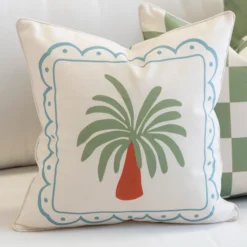 Tropica cushion with stylised palm tree and blue bordered frame design.