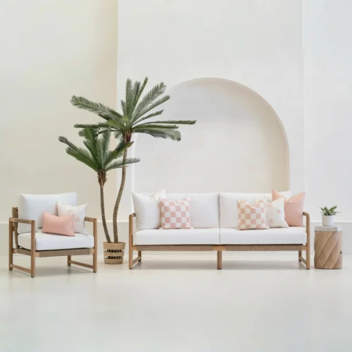 Tropica pink cushions styled on sofa and chair in outdoor setting.