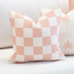 Tropica pink check cushion with soft white squares on outdoor seating.