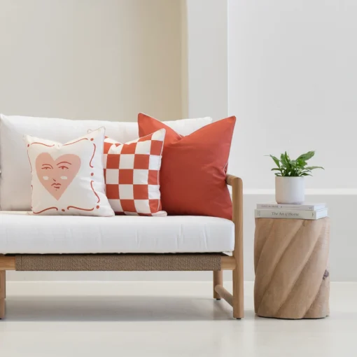 Tropica red cushions with heart and check patterns on outdoor sofa.