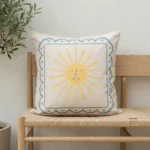 Tropica cushion with yellow sun motif and blue bordered frame on bench.
