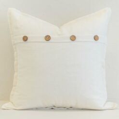 White linen button cushion cover with a crisp, fresh finish and natural wooden button detail for subtle texture.