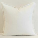 White linen button cushion cover finished with subtle wooden buttons for a clean, understated detail.