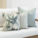 Close-up of Wildgrove Frond cushions with leafy pattern and striped design.