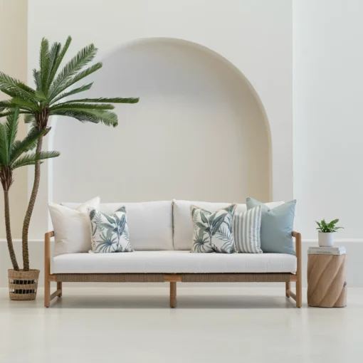 Tropica red cushions with check and face designs on outdoor sofa.