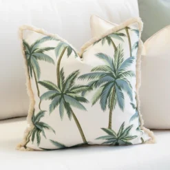 Close-up of Wildgrove Palm cushion with green palm tree pattern and fringe edge.