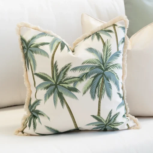 Close-up of Wildgrove Palm cushion with green palm tree pattern and fringe edge.