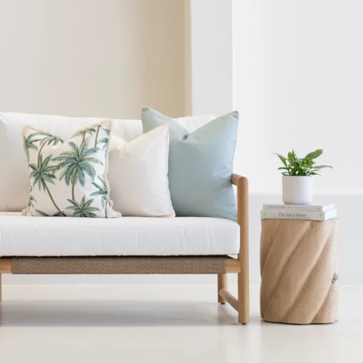 Wildgrove Frond cushions with leafy pattern and stripes on outdoor sofa.