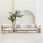 Wildgrove Palm cushions styled on outdoor sofa and chair with palm patterns.