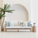 Wildgrove Palm cushions with soft blue tones and palm prints on sofa.